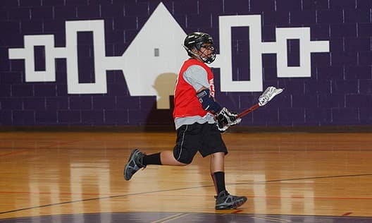 Playing lacrosse