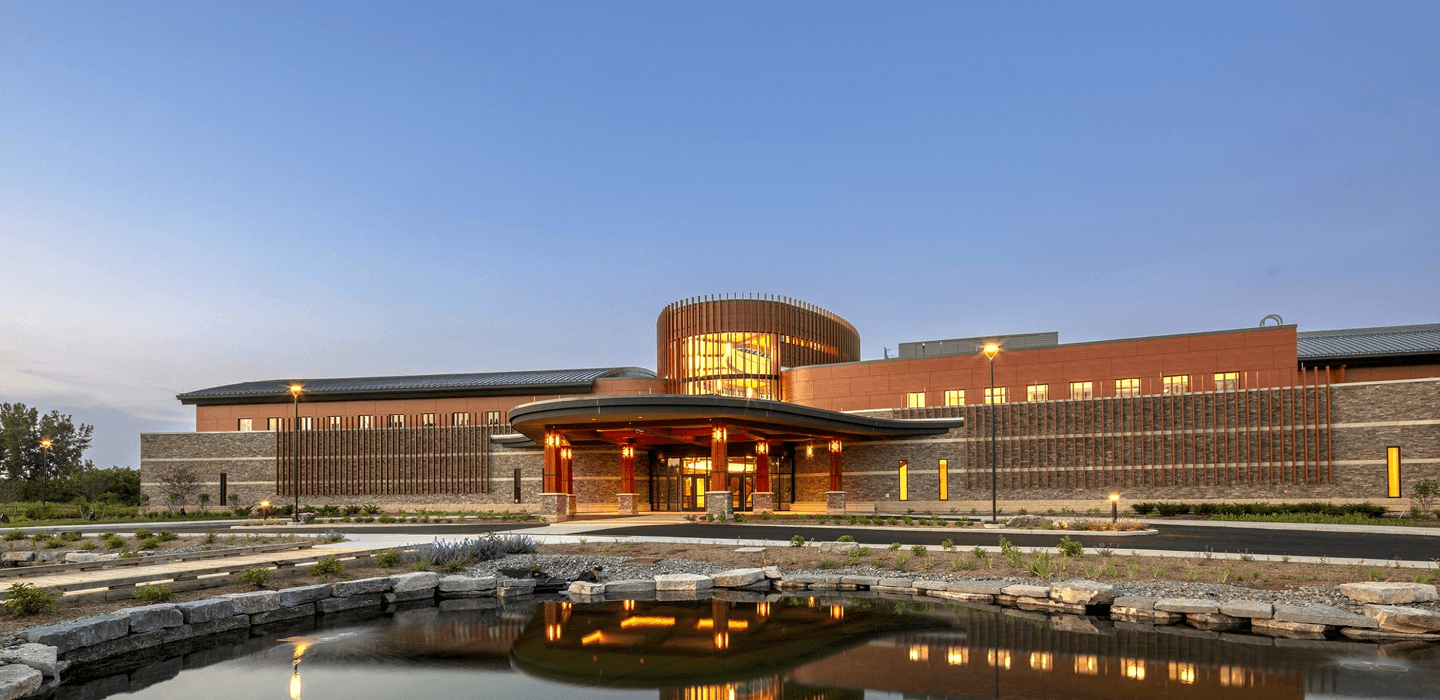 a building reflecting in a pond