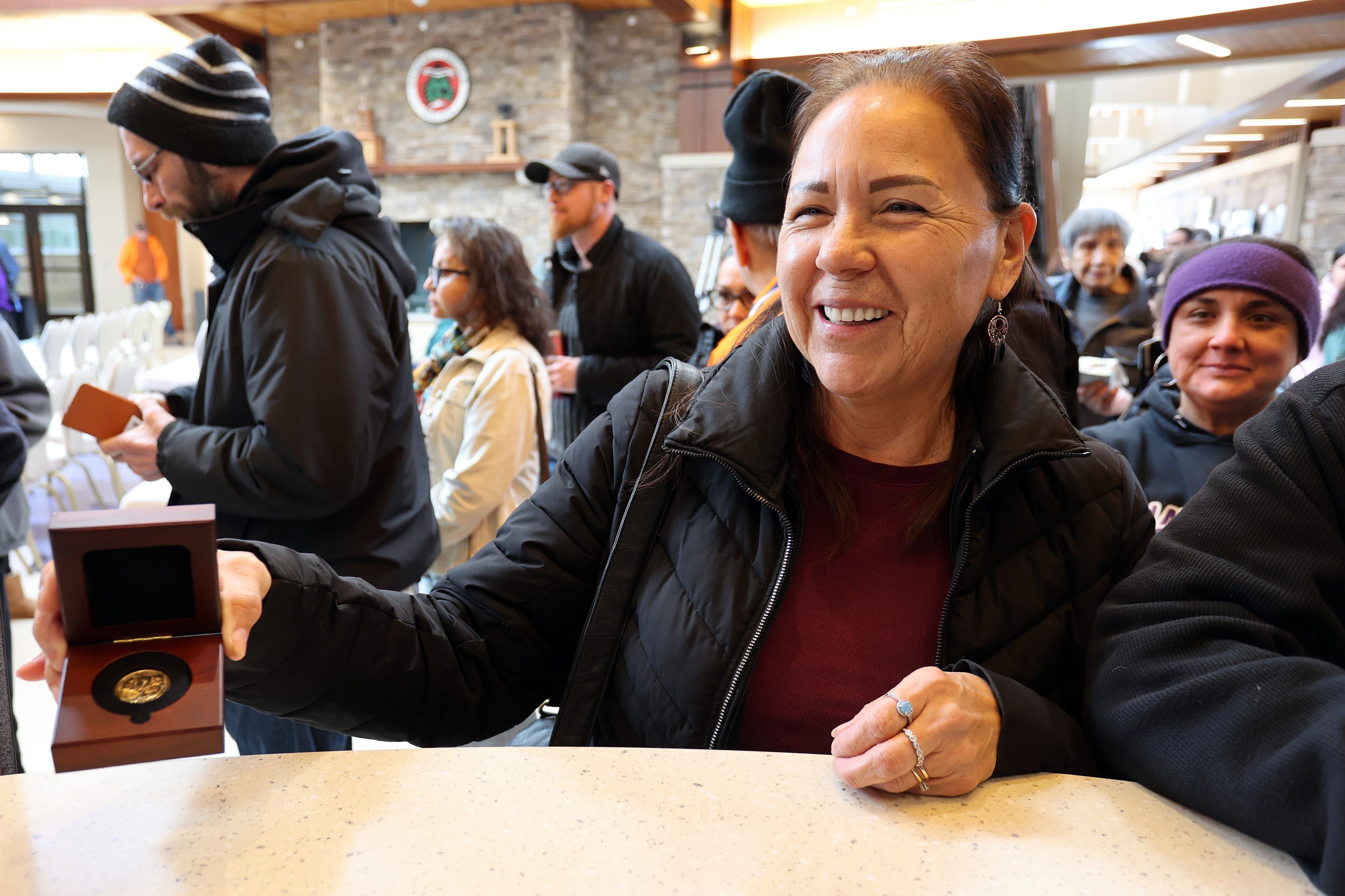 Oneida Indian Nation Member receives a Polly Cooper coin.